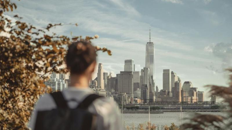 male student standing looking at a landmark